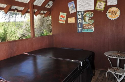 Large hot tub in outdoor roofed building with open sides